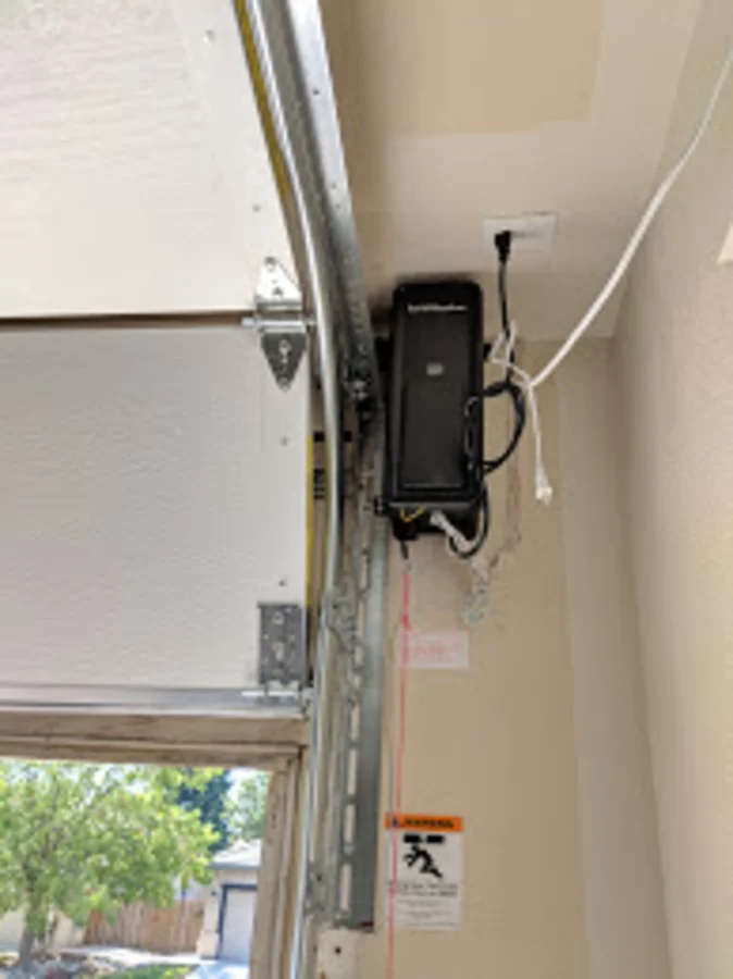 High-lift garage door track compared to a standard door — the door rises higher before turning back