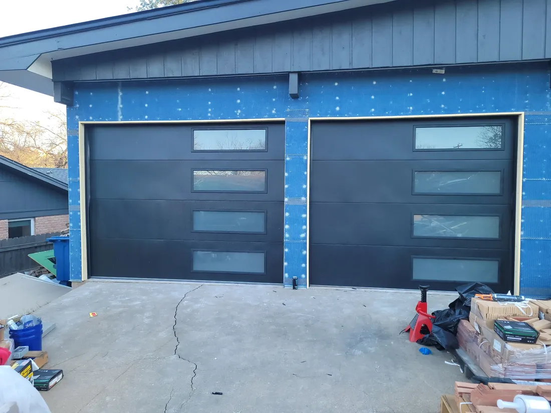A wide, modern garage door on an Austin-area home — Edge Garage Doors new door install that lifts curb appeal and resale value