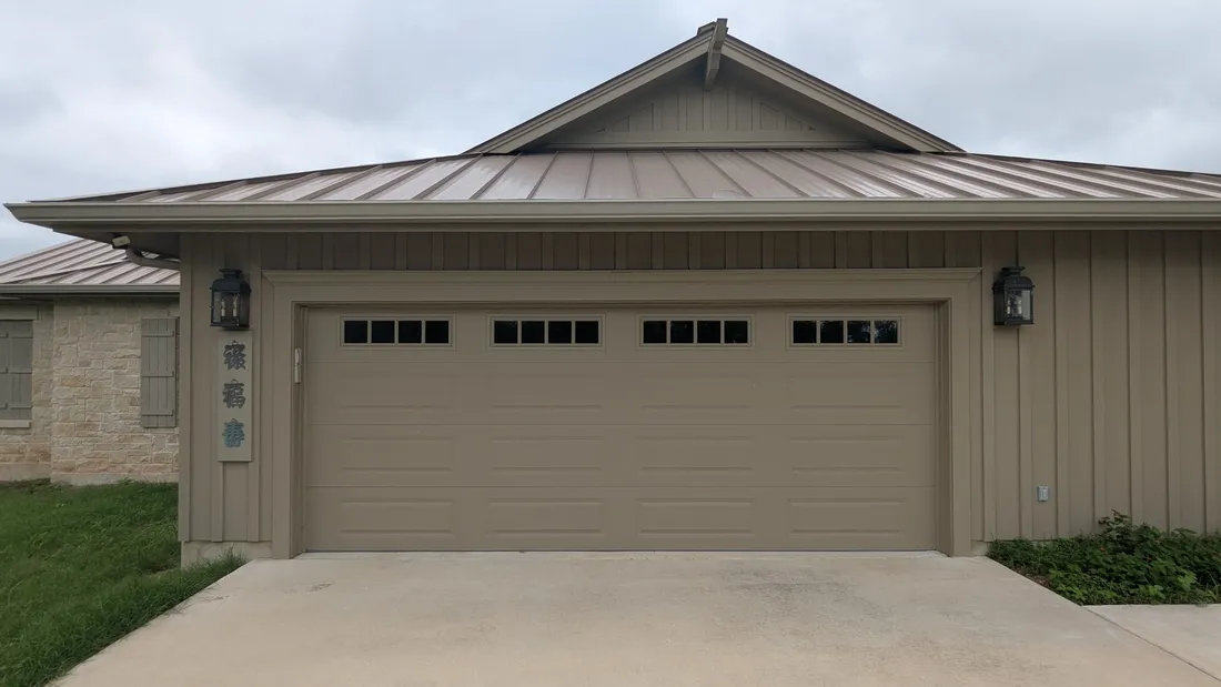 One wide garage door on a slab-on-grade Austin home after an Edge Garage Doors two-to-one conversion